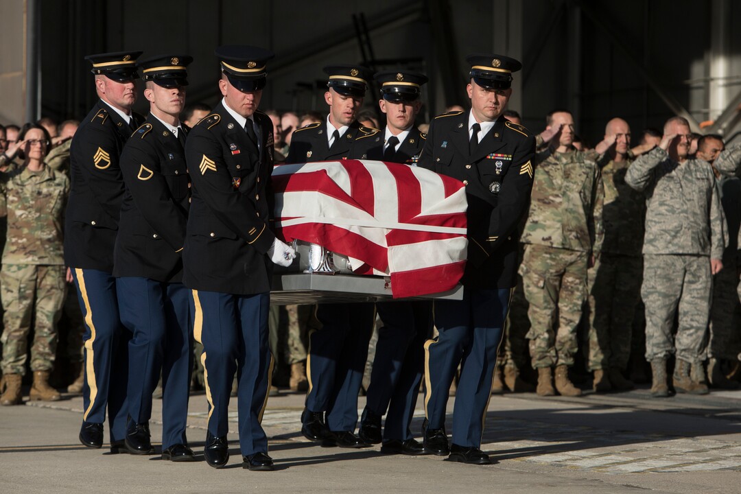 (Matt Herp  |  The Ogden Standrad Examiner/Pool) Utah National Guard Honor Guard Detail members carry a casket containing the remains of Maj. Brent R. Taylor at Roland R. Wright Air National Guard Base in Salt Lake City, Utah, on Wednesday, Nov. 14, 2018. Taylor, 39, of North Ogden, died Nov. 3, 2018, in Afghanistan of wounds sustained from small arms fire. His funeral is scheduled for Saturday, Nov. 17, in Ogden.