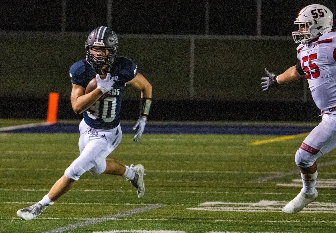 (Rick Egan | The Salt Lake Tribune) The Leopards Jonathan Brambila (55) chases the Chargers Dylan Carlsen (30) as he runs the ball,  in prep football action between Corner Canyon Chargers and the East Leopards, on Saturday, Aug. 21, 2021.