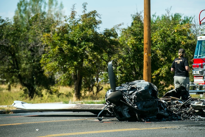 (Chris Detrick  |  The Salt Lake Tribune)  The scene of a plane crash at 1900 West and 4500 South in Roy Tuesday, September 12, 2017. The pilot of a single-engine airplane survived a fiery crash on a street in Roy Tuesday afternoon, authorities said. Roy police Sgt. Matthew Gwynn said the pilot was transported to a hospital “out of precaution,” as was the driver of a car that the plane hit.