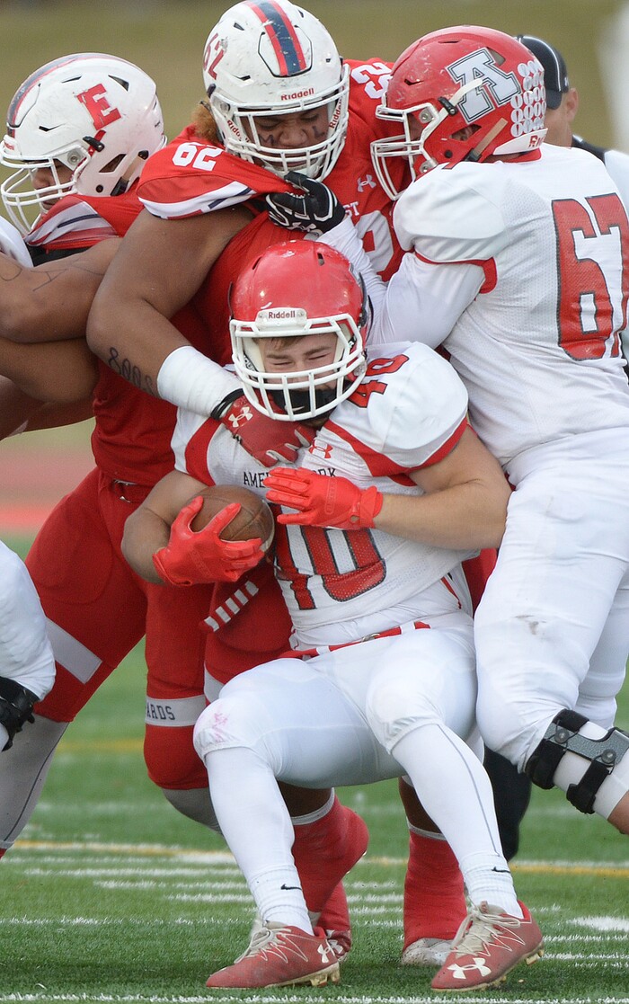(Leah Hogsten  |  The Salt Lake Tribune) American Fork's quarterback Bronson Barron is taken down by Apu Ika. American Fork High School boys' football team East High School during their class 6A state quarterfinal football game, Friday, November 3, 2017