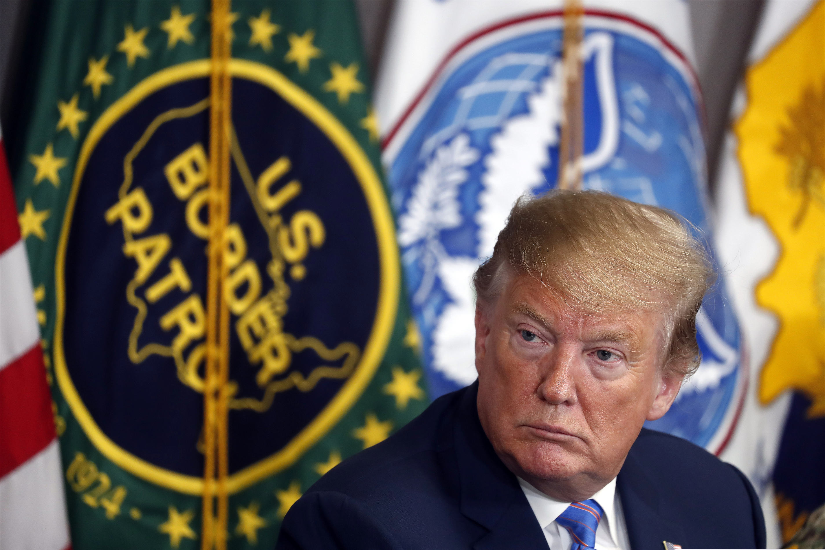 FILE - In this April 5, 2019 file photo, President Donald Trump participates in a roundtable on immigration and border security at the U.S. Border Patrol Calexico Station in Calexico, Calif. A federal judge is expected to decide Friday, May 24, 2019 whether to block the White House from spending billions of dollars to build a wall on the Mexican border with money secured under President Donald Trump's declaration of a national emergency. California and 19 other states, along with environmentalists, civil liberties groups and communities along the border, are seeking a temporary injunction to halt construction plans.(AP Photo/Jacquelyn Martin, File)