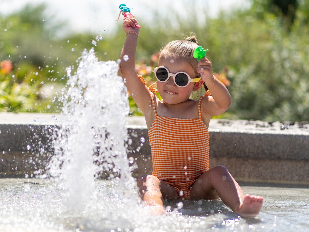 (Rick Egan | The Salt Lake Tribune) Lainey Holmes cools off in a fountain at Bountiful Townsquare, on Friday, July 21, 2023.