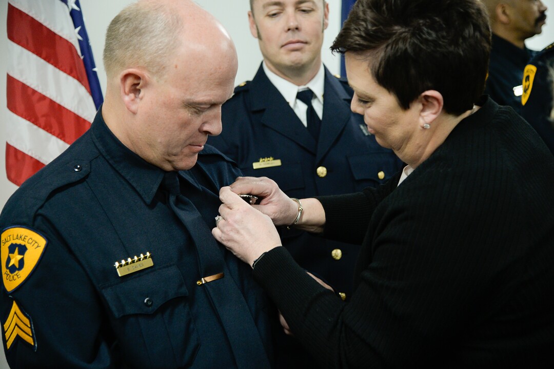 (Francisco Kjolseth  |  The Salt Lake Tribune)  Salt Lake City Airport Police Sgt. Bruce Davies is pinned with a new badge by his wife Laurie during a ceremony to retire their former patch and badge as they are subsumed into the Salt Lake City Police Department on Tuesday, Feb. 26, 2019. 