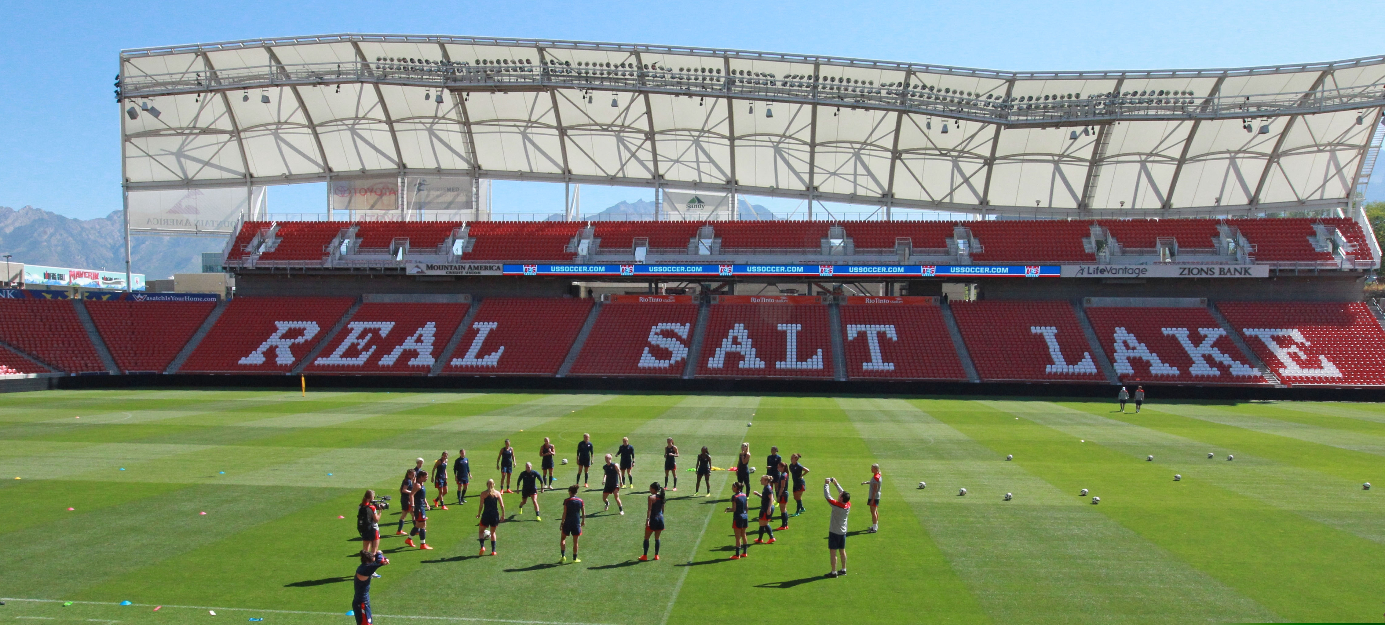 FILE - In this Sept. 12, 2014 file photo, members of the U.S. Women's National team warm up during practice at Rio Tinto Stadium in Sandy, Utah. Pro soccer returns to the U.S. next month when the National Women's Soccer League starts a 25-game tournament in a pair of stadiums in Utah that will be kept clear of fans to protect players from the coronavirus. Players from the nine teams will train and live at two Salt Lake City-area hotels, the league announced Wednesday, May 27, 2020. (AP Photo/Rick Bowmer, File)