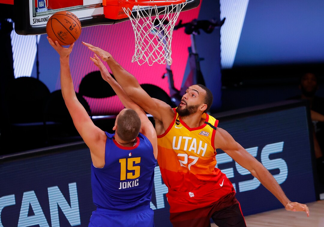 Utah Jazz's Rudy Gobert, right, defends against Denver Nuggets' Nikola Jokic during the third quarter of Game 4 of an NBA basketball first-round playoff series, Sunday, Aug. 23, 2020, in Lake Buena Vista, Fla. (Kevin C. Cox/Pool Photo via AP)