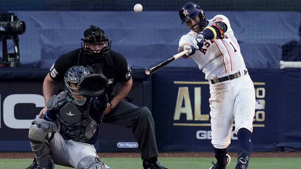 Players celebrate Houston Astros Carlos Correa hits a walk off home run during the ninth inning in Game 5 of a baseball American League Championship Series, Tuesday, Dec. 15, 2020, in San Diego. The Astros defeated the Rays 4-3 and the Rays lead the series 3-2 games. (AP Photo/Jae C. Hong)