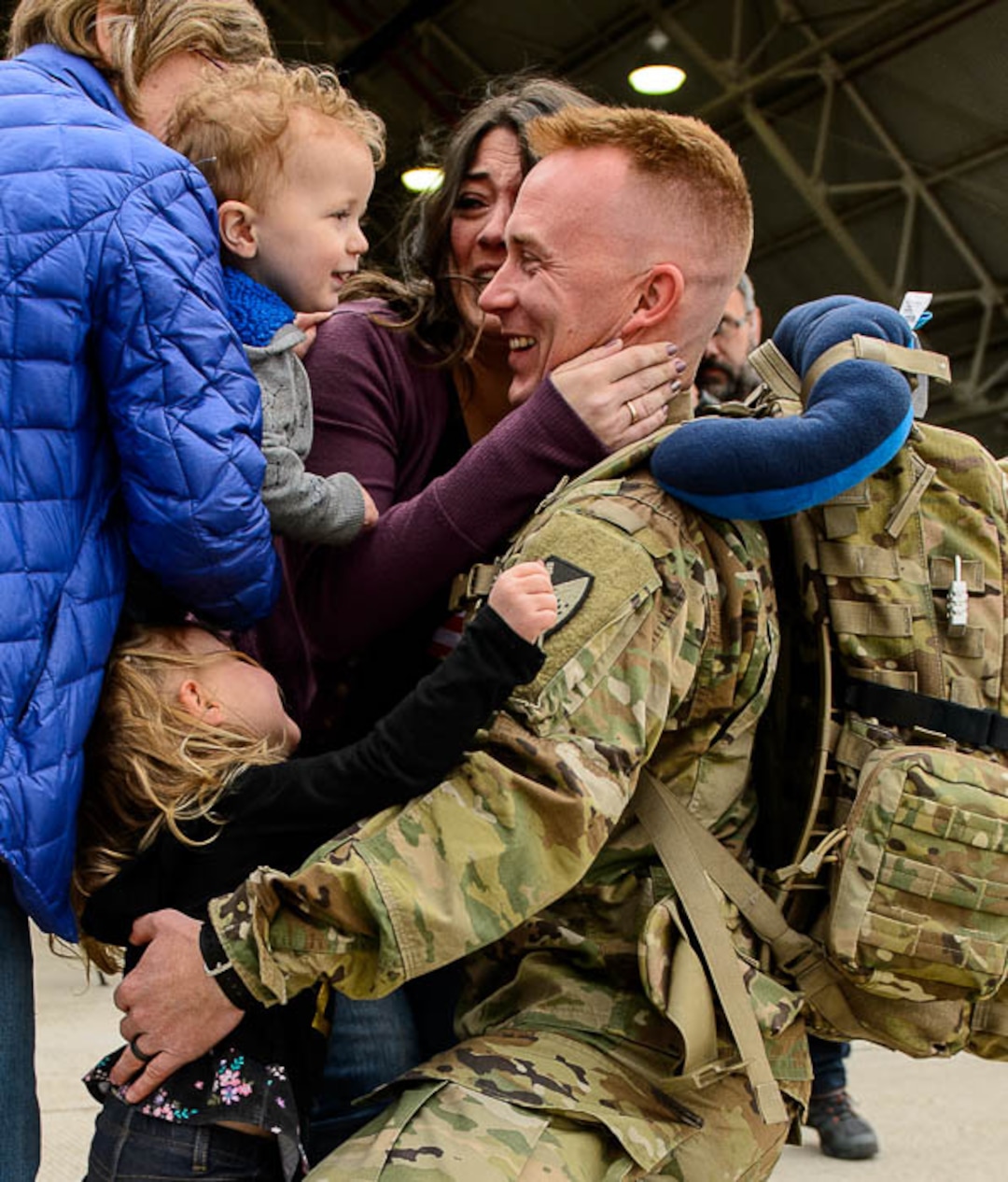 (Trent Nelson  |  The Salt Lake Tribune)  Staff Sergeant Sean Sullivan is welcomed home by his wife Kim and children Mae and Simon as almost 100 Soldiers from Utah Army National Guard’s Echo Battery, 1st Battalion, 145th Field Artillery, “Big Red” return after a 10-month Middle East deployment, on Tuesday April 9, 2019 at Wright Air Base in Salt Lake City. Sullivan's mother Ilean at left.