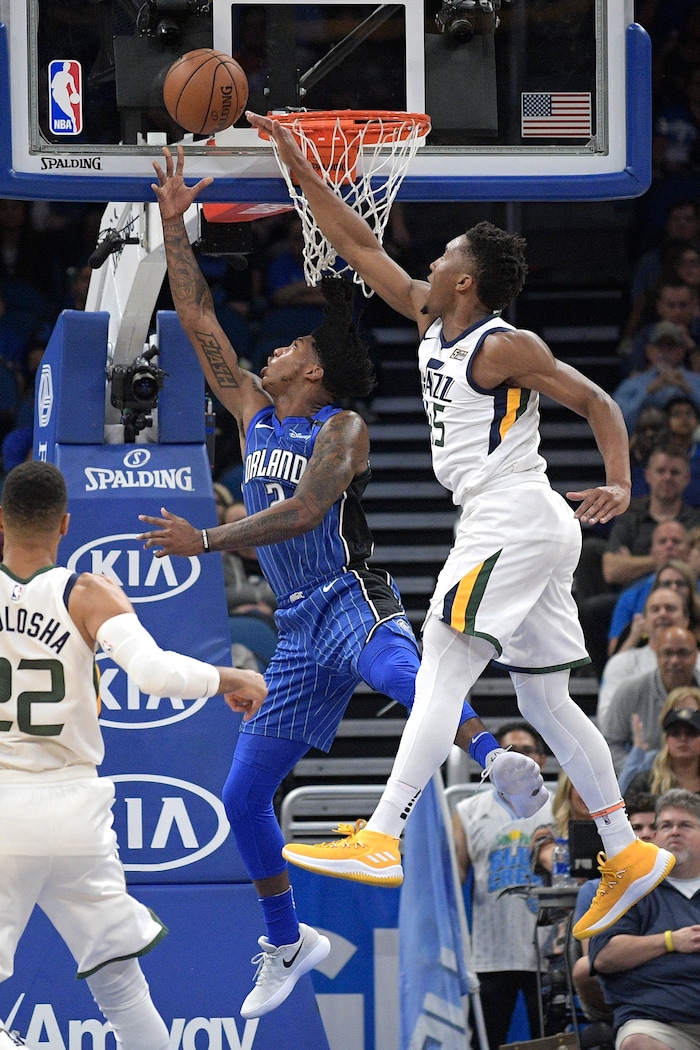 Orlando Magic guard Elfrid Payton (2) goes up for a shot between Utah Jazz forward Thabo Sefolosha (22) and guard Donovan Mitchell (45) during the first half of an NBA basketball game Saturday, Nov. 18, 2017, in Orlando, Fla. (AP Photo/Phelan M. Ebenhack)