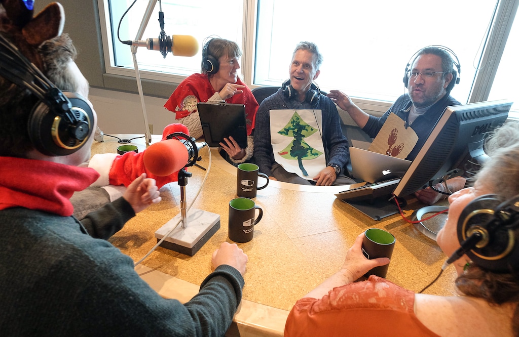 (Francisco Kjolseth | Tribune file photo) Radio West host Doug Fabrizio, center, gets into the holiday spirit with Cheryl Cluff, center left, and operations director Michael Havey during a recent gathering at the KUER studio. After taking the summer off, "RadioWest" will return as a weekly show on Sept. 13.