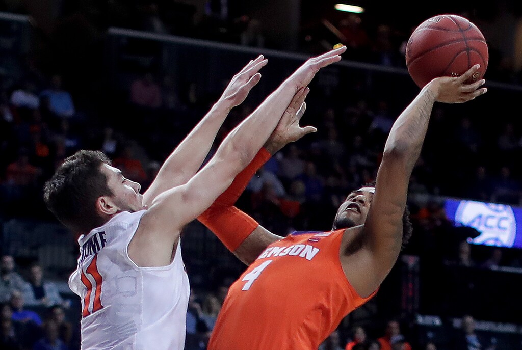 Clemson guard Shelton Mitchell (4) shoots against Virginia guard Ty Jerome (11) during the first half of an NCAA college basketball game in the Atlantic Coast Conference men's tournament semifianls Friday, March 9, 2018, in New York. (AP Photo/Julie Jacobson)
