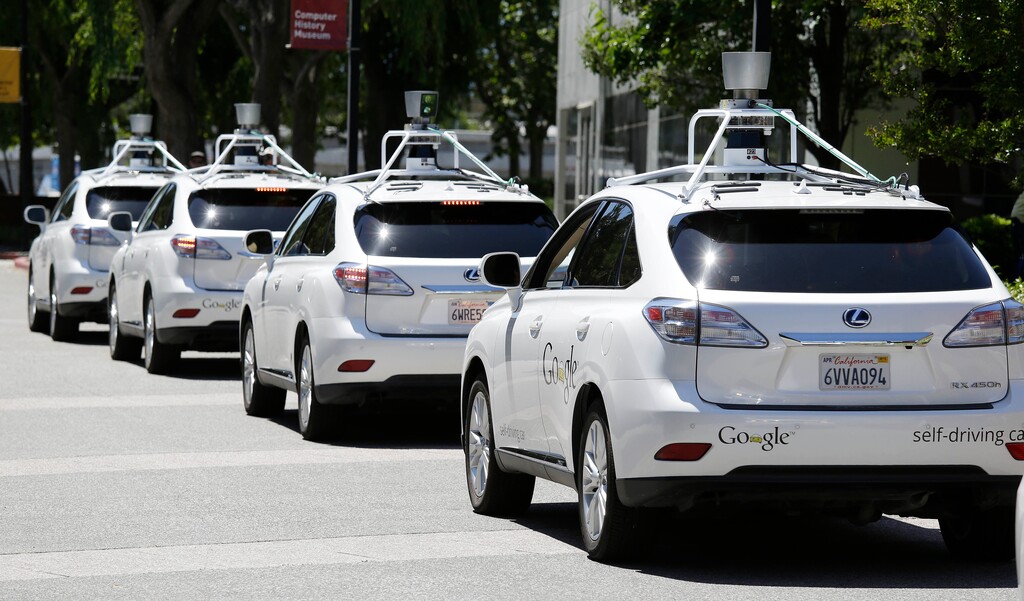 (AP Photo/Eric Risberg) In this May 13, 2014, file photo, a row of Google self-driving cars stands outside the Computer History Museum in Mountain View, Calif. A task force looking at future transportation in Utah was told such cars may kill mass transit.