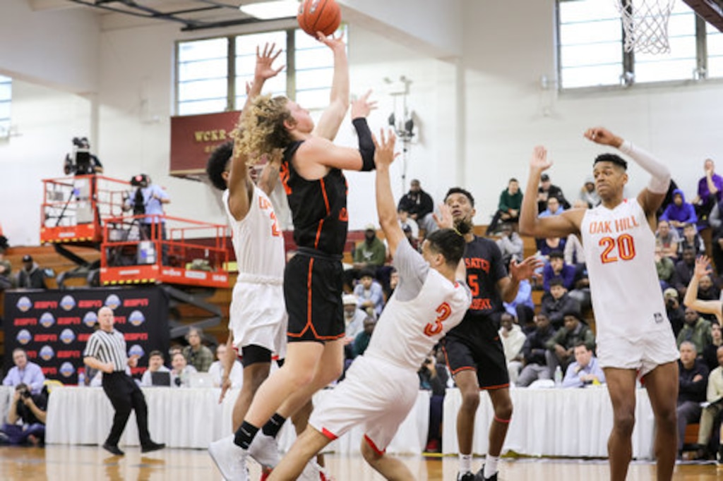 Wasatch Academy star Caleb Lohner (dark jersey) attempts a shot against Oak Hill Academy in the GEICO National Championships last April in New York City. | Photo courtesy of Wasatch Academy basketball.