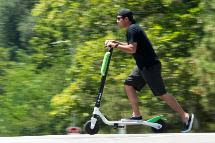 (Rick Egan  |  The Salt Lake Tribune)      Mike Ceja, rides a Lime Scooters, in downtown Salt Lake City, Monday, July 30, 2018.

 