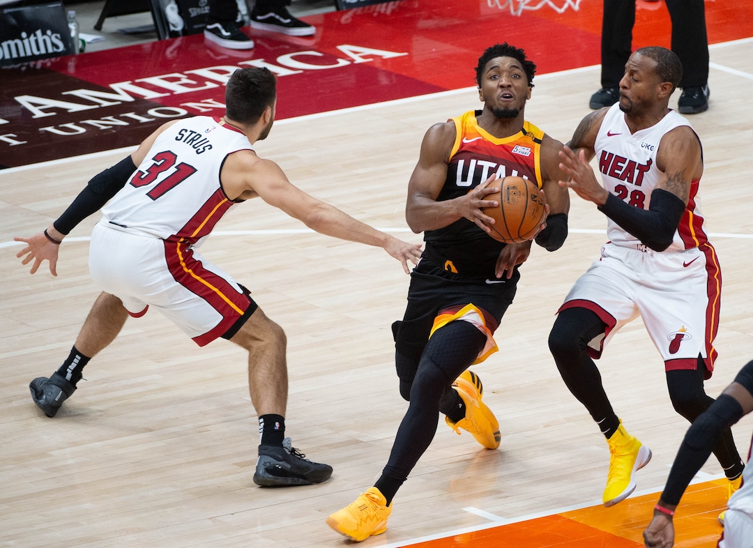(Francisco Kjolseth  | The Salt Lake Tribune) Utah Jazz guard Donovan Mitchell (45) pushes past Miami Heat guard Max Strus (31) and Miami Heat forward Andre Iguodala (28) as the Utah Jazz take on the Miami Heat at Vivint Smart Home Arena in Salt Lake City, on Saturday, Feb. 13, 2021.