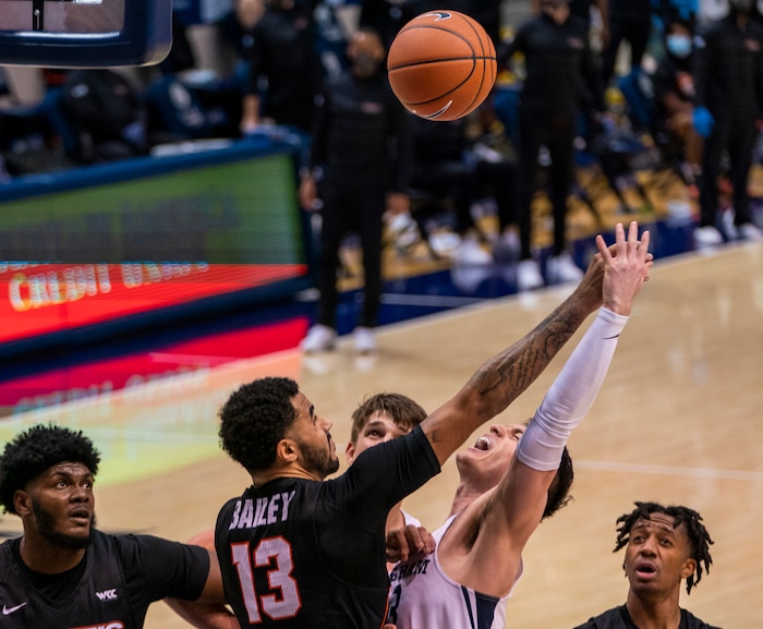 (Rick Egan | The Salt Lake Tribune)  Brigham Young Cougars guard Alex Barcello (13) is fouled by Pacific Tigers forward Jeremiah Bailey (13), in basketball action at the Marriott Center in Provo, on Saturday, Jan. 30, 2021.