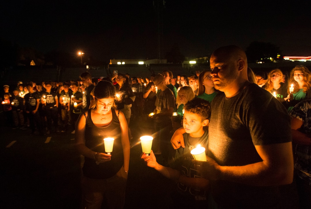 (Rick Egan  |  The Salt Lake Tribune)Hillcrest high students and supporters light candles on the football field, during a candlelight vigil in honor of coach Cazzie Brown, at Hillcrest High School, Monday, August 28, 2017.