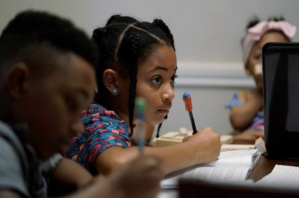 (Eric Gay | The Associated Press) Jacoby Brown, 11, left, and sister Felicity, 9, practice math at their home in Austin, Texas, Tuesday, July 13, 2021. The U.S. Census Bureau reported in March that the rate of households homeschooling their children rose to 11% by September 2020, more than doubling from 5.4% just six months earlier.