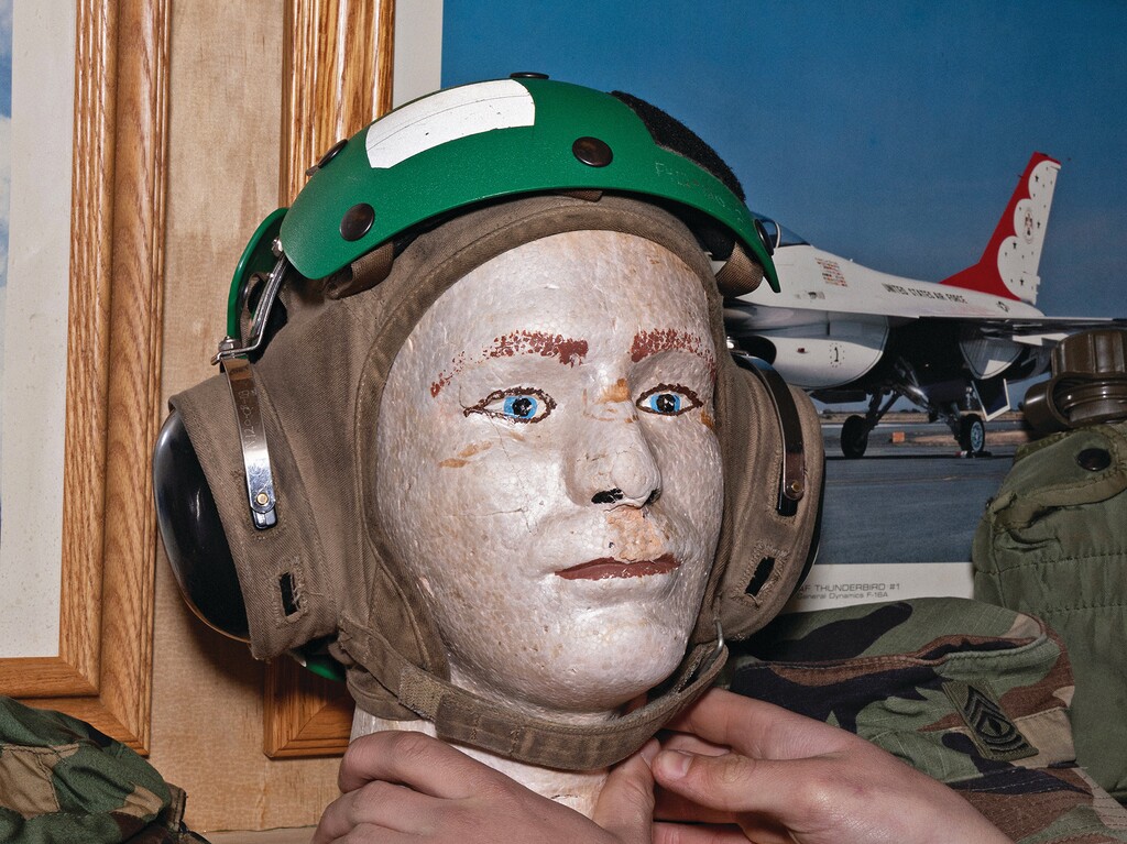 Luke Morrison adjusts a helmet on display in his military museum in Danville, Vt., May 3, 2026. On the edge of a goat farm in Vermont’s Northeast Kingdom sits Luke’s Military Museum, an aluminum trailer that serves as a loving testament to the nation’s veterans. (Amina Gingold/The New York Times)