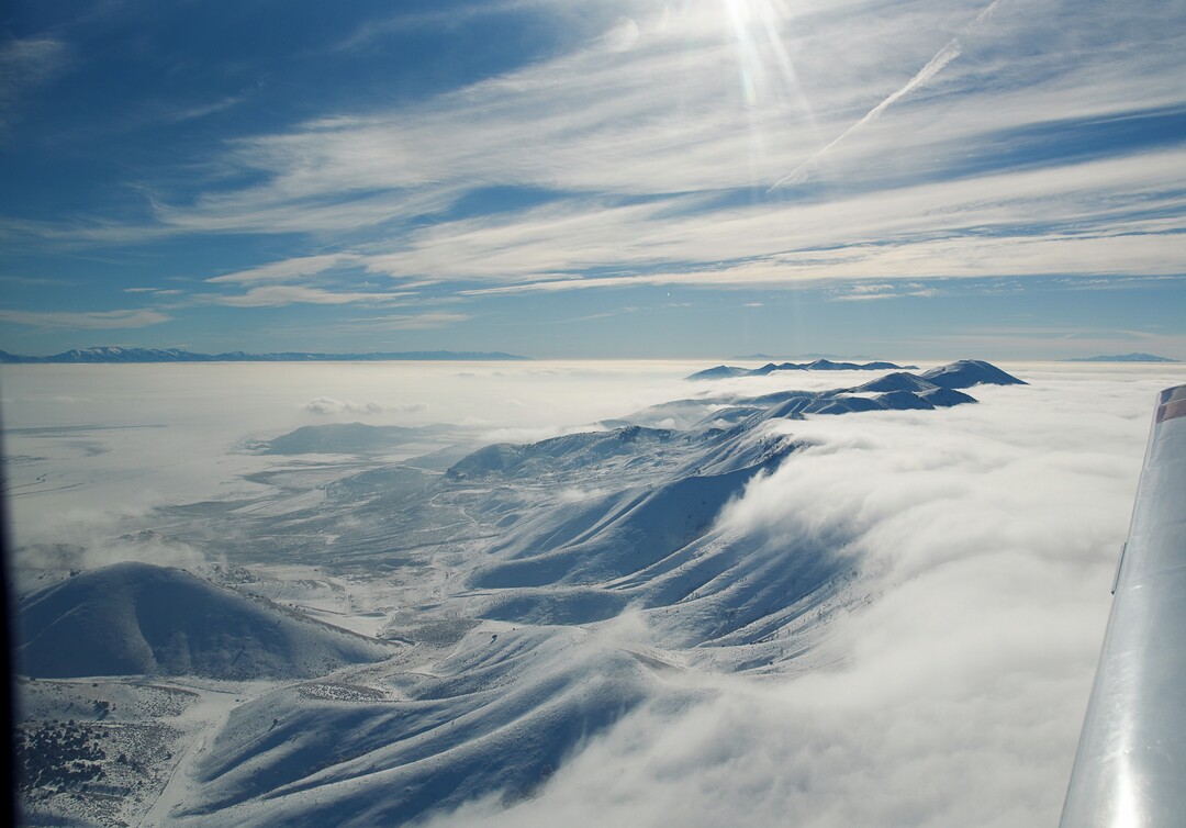 (Francisco Kjolseth  |  The Salt Lake Tribune)  The Promontory Mountains and the Wasatch Range beyond push through the deteriorating air quality under inversion conditions on Monday, Jan. 14, 2019, obscuring the ground below as pilot Jeff Greenland takes every opportunity to fly above the poor conditions. Over the radio with Salt Lake Approach before landing he can be heard saying "thanks for keeping us all safe during the shutdown," as the longest government shutdown in U.S. history drags on.