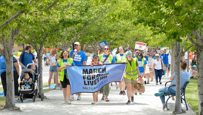 (Chris Samuels | The Salt Lake Tribune) Marchers walk in support of increased gun safety measures at the Capitol in Salt Lake City, Saturday, June 11, 2022.
