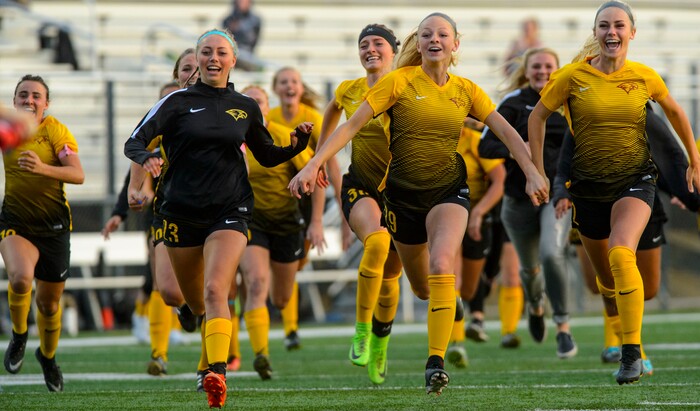(Steve Griffin | The Salt Lake Tribune) Maple Mountain players charge the field as they defeat East in a shootout during 5A semifinal girl's soccer match at Juan Diego High School in Draper Tuesday October 17, 2017.