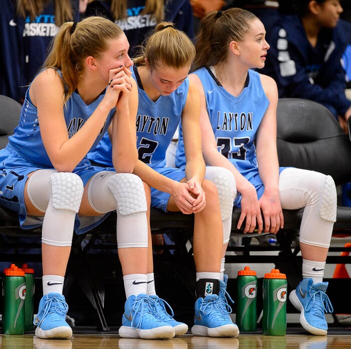 (Trent Nelson | The Salt Lake Tribune)  Layton's Gracey Criswell (21), Layton's Daisy Barker (12), and Layton's Kaitlyn Viator (33)  on the bench as Layton faces Copper Hills in the 6A High School Girls' Basketball Tournament at SLCC in Taylorsville, Thursday Feb. 22, 2018.