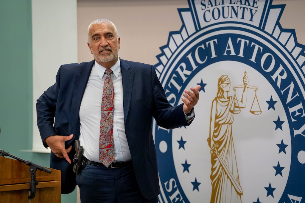 (Francisco Kjolseth | The Salt Lake Tribune) Salt Lake County District Attorney Sim Gill uses his holstered gun as a visual reference during a news conference on Thursday, July 22, 2021 during which he said West Valley City Sgt. Tyler Longman was legally justified when he shot and killed  Michael Chad Breinholt inside a police station in 2019.