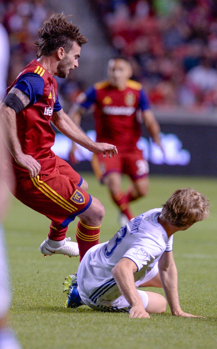 Leah Hogsten | The Salt Lake Tribune San Jose Earthquakes midfielder Florian Jungwirth (23) slides into Real Salt Lake midfielder Kyle Beckerman (5) as Real Salt Lake hosts the San Jose Earthquakes at Rio Tinto Stadium in Sandy, Utah, Saturday, June 23, 2018.