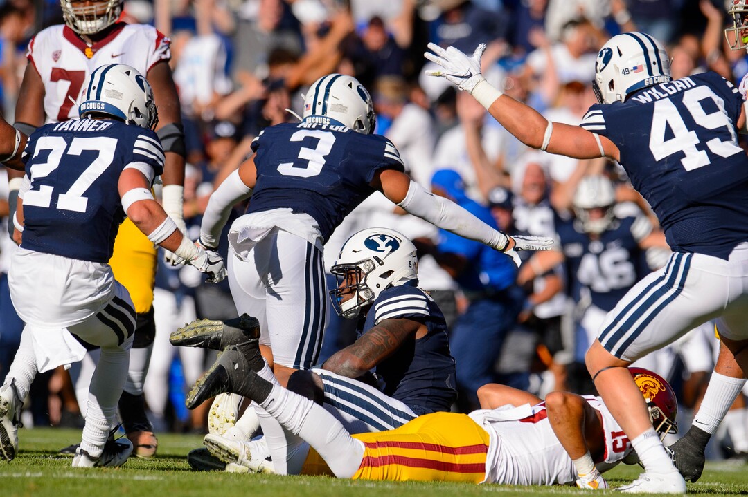 (Trent Nelson  |  The Salt Lake Tribune)  BYU celebrates after Brigham Young Cougars defensive back Dayan Ghanwoloku (5) makes a game-winning interception in overtime as BYU hosts USC, NCAA football in Provo on Saturday Sept. 14, 2019.