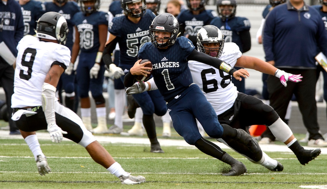 (Steve Griffin  |  The Salt Lake Tribune)  Corner Canyon quarterback Zach Wilson scrambles away from Highland  defense during the Class 5A state quarterfinal football game at Corner Canyon in Draper Friday November 3, 2017.