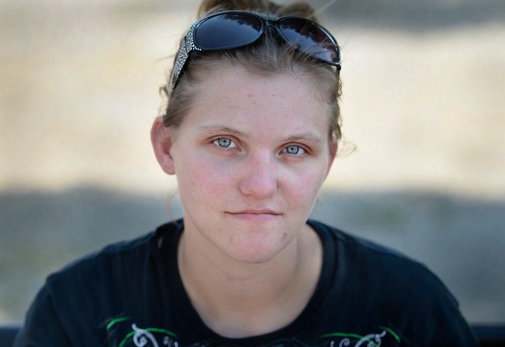 (Scott Sommerdorf | The Salt Lake Tribune) Heroin user Kellie Sorenson sits on a park bench near the needle exchange tent on 500 West & 300 South, Thursday, August 3, 2017.