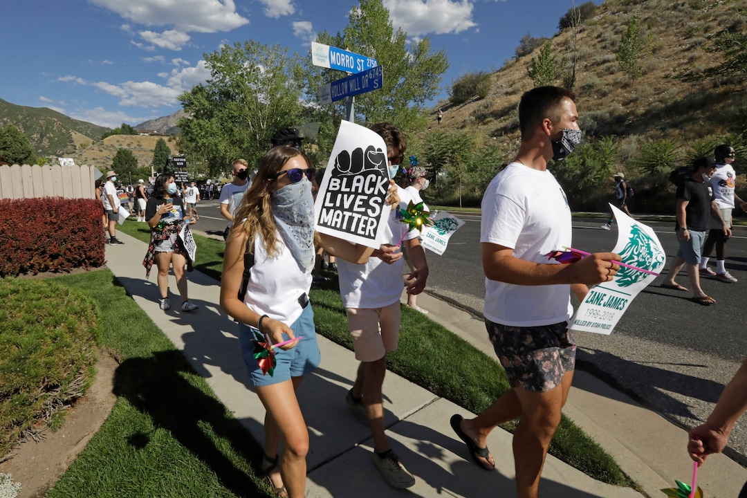 Protesters march Sunday, Aug. 2, 2020, in Cottonwood Heights, Utah. The protest was a "March for Justice" focused largely around Zane James, who was fatally shot police in Cottonwood Heights in 2018. (AP Photo/Rick Bowmer)