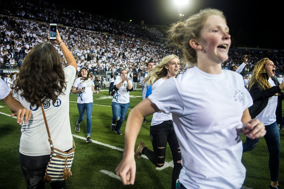 (Chris Detrick  |  The Salt Lake Tribune)  Utah State Aggies students run onto the field after the game at Merlin Olsen Field at Maverik Stadium Friday, September 29, 2017. Utah State Aggies defeated Brigham Young Cougars 40-24.