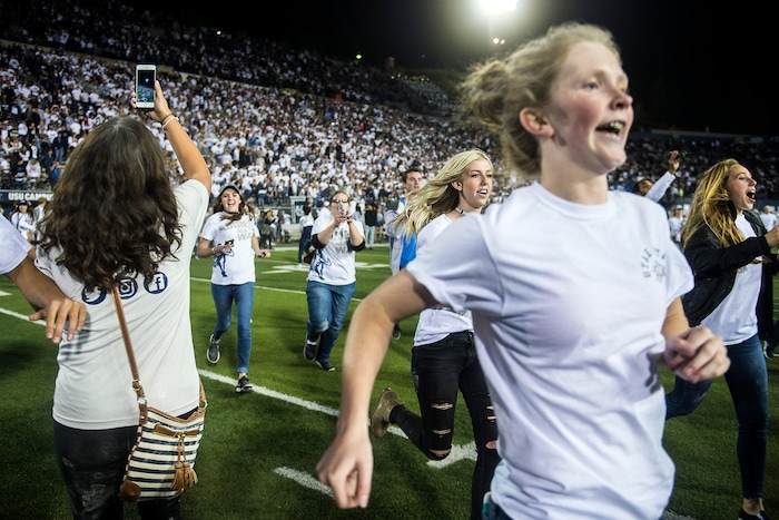 (Chris Detrick  |  The Salt Lake Tribune)  Utah State Aggies students run onto the field after the game at Merlin Olsen Field at Maverik Stadium Friday, September 29, 2017. Utah State Aggies defeated Brigham Young Cougars 40-24.