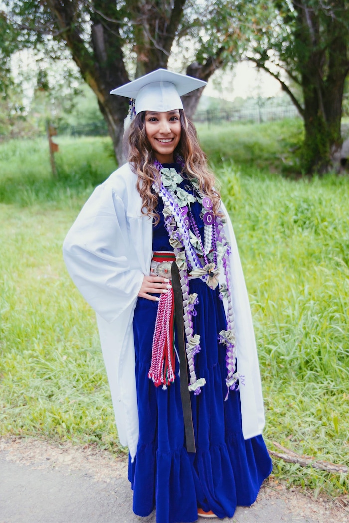 (Photo courtesy of Tasheena Savala) Pictured is Tasheena Savala with leis and decorations added after her graduation ceremony on May 29, 2019.