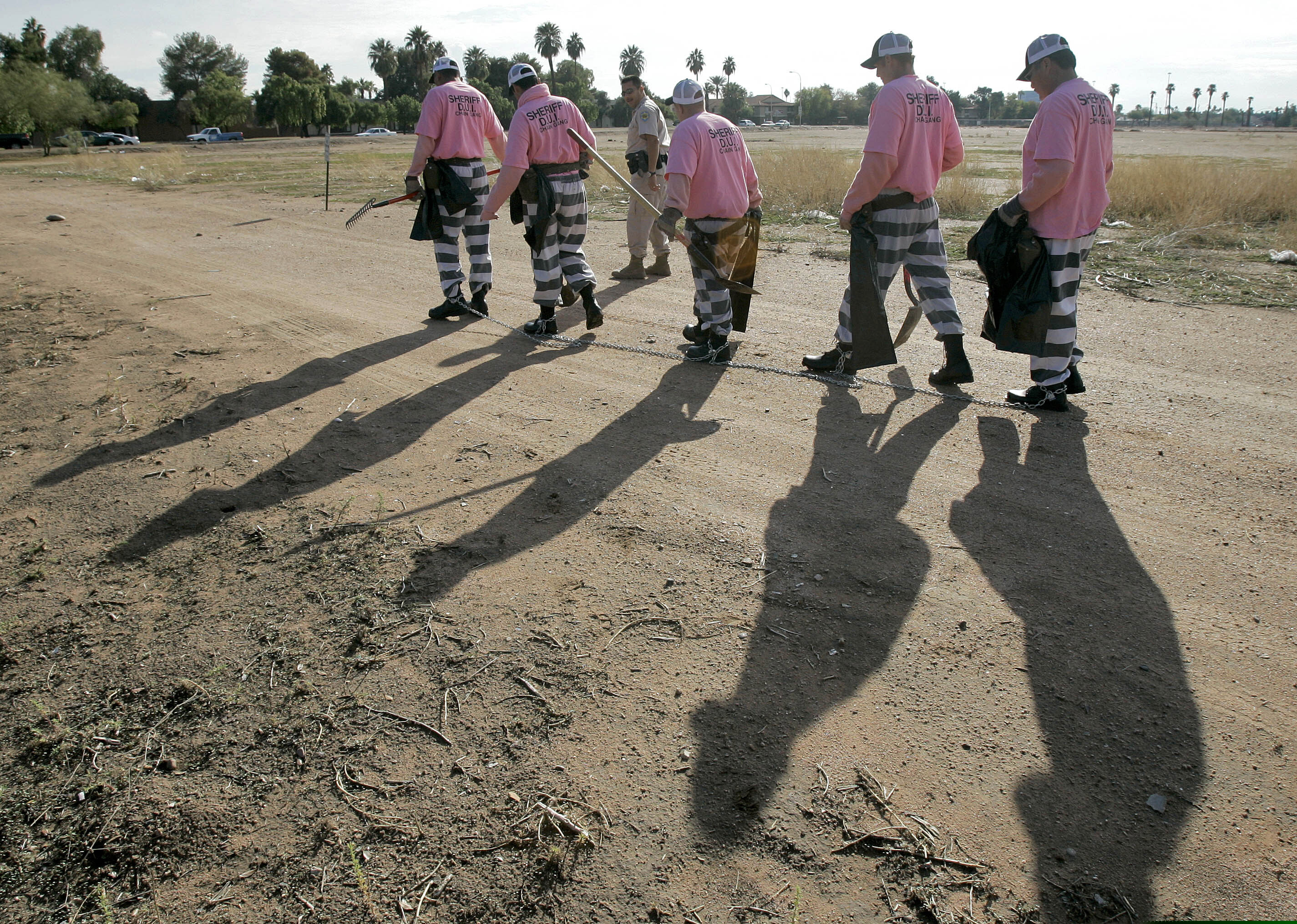 (Matt York | AP file photo) Members of the Maricopa County DUI chain gang are escorted to their assignment in Phoenix, Dec. 11, 2007. National lawmakers are expected on Wednesday, Dec. 2, 2020, to introduce a joint resolution aimed at striking language from the U.S. Constitution that enshrines a form of slavery in America’s foundational documents. Many Americans will recognize modern-day prison labor as chain gangs deployed from prison facilities for agricultural and infrastructure work.