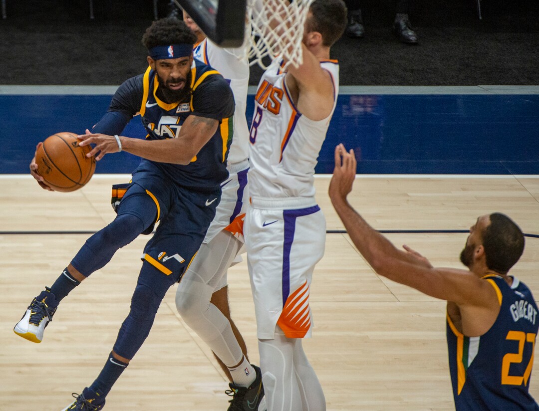 (Rick Egan | The Salt Lake Tribune) Utah Jazz guard Mike Conley (10) takes the ball under the basket, as Phoenix Suns forward Frank Kaminsky (8) defends, in NBA action between the Utah Jazz and the Phoenix Suns, on Thursday, Dec. 31, 2020.