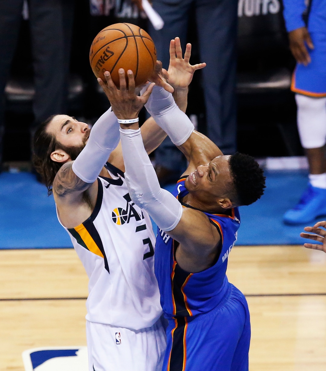 Utah Jazz guard Ricky Rubio, left, and Oklahoma City Thunder guard Russell Westbrook reach for a rebound during the second half of Game 5 of an NBA basketball first-round playoff series in Oklahoma City, Wednesday, April 25, 2018. (AP Photo/Sue Ogrocki)