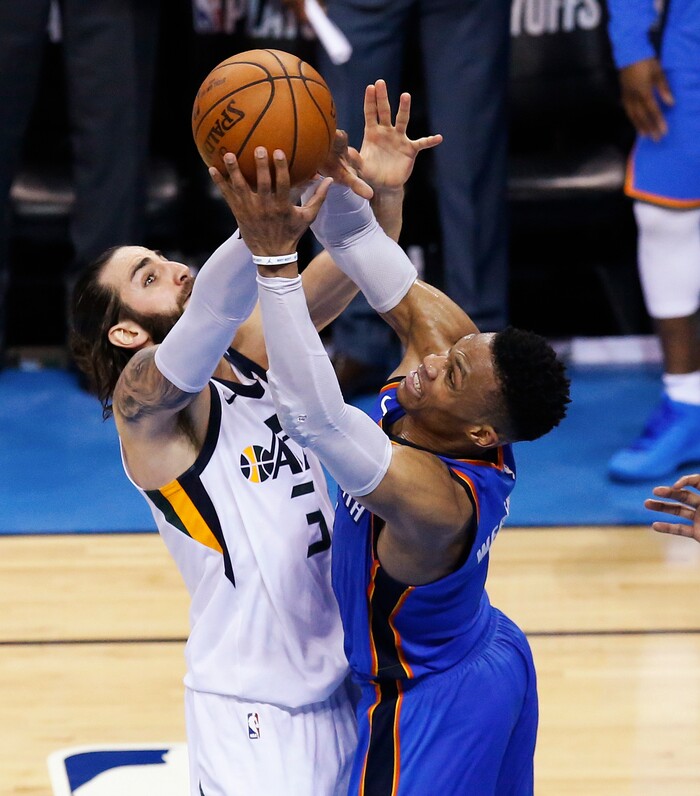 Utah Jazz guard Ricky Rubio, left, and Oklahoma City Thunder guard Russell Westbrook reach for a rebound during the second half of Game 5 of an NBA basketball first-round playoff series in Oklahoma City, Wednesday, April 25, 2018. (AP Photo/Sue Ogrocki)