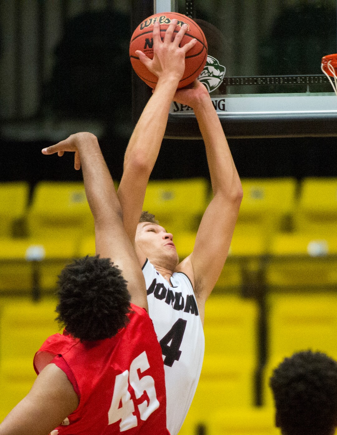 (Rick Egan  |  The Salt Lake Tribune)    Jordan Beatdiggers Dyson Koehler (4)shoots as East Leopards Mikey Frazier (45) defends, in 5A basketball playoff action between the East Leopards and the Jordan Beatdiggers at the UCCU Center in Orem, Monday, Feb. 26, 2018.
