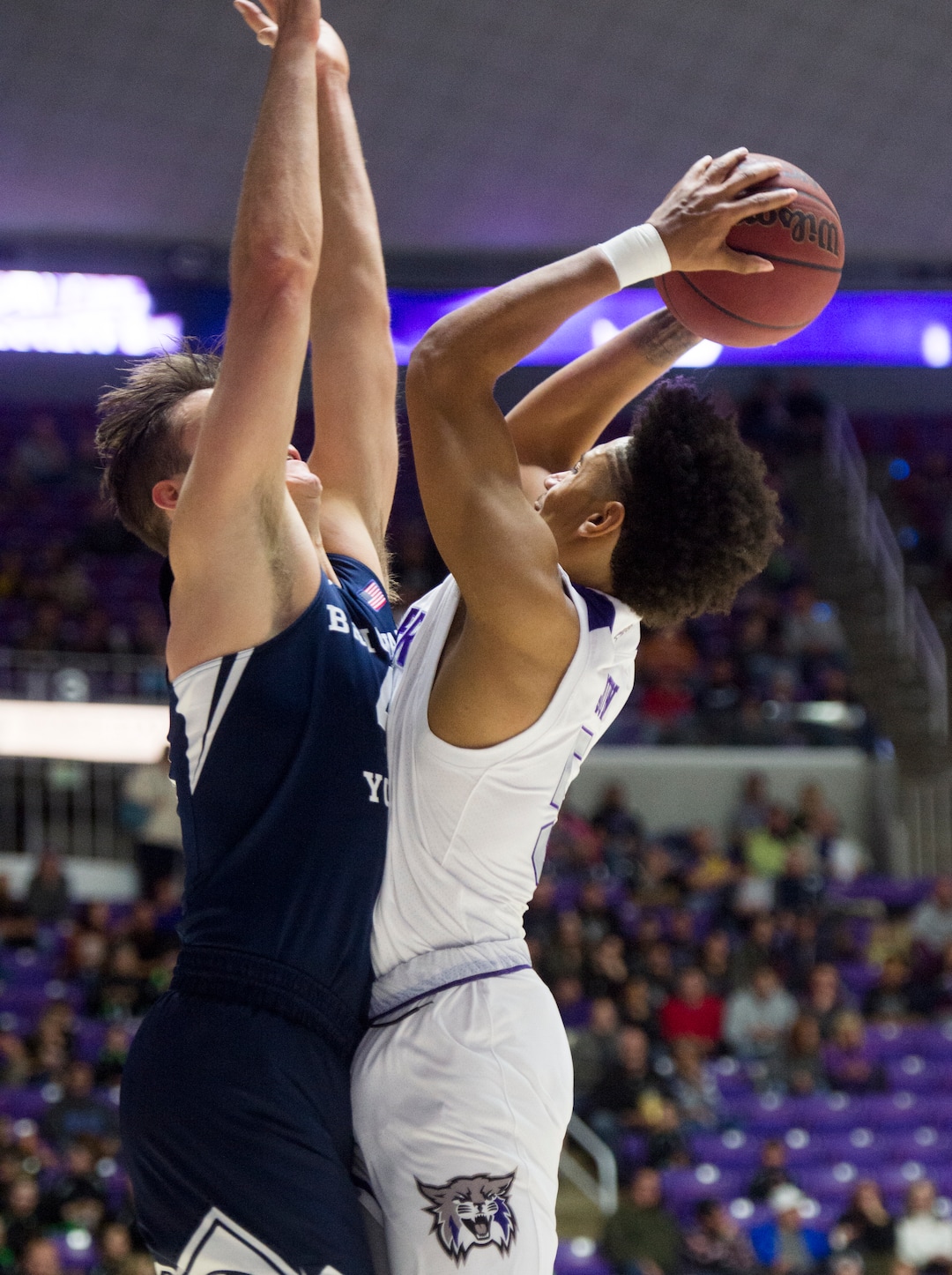 (Rick Egan  |  The Salt Lake Tribune)      Weber State guard Cody John (5) collides with Brigham Young Cougars forward Luke Worthington (41) as he scores for the Wildcats, in basketball action between Brigham Young Cougars and Weber State Wildcats, at the Dee Event Center in Ogden, Saturday, Dec. 1, 2018.