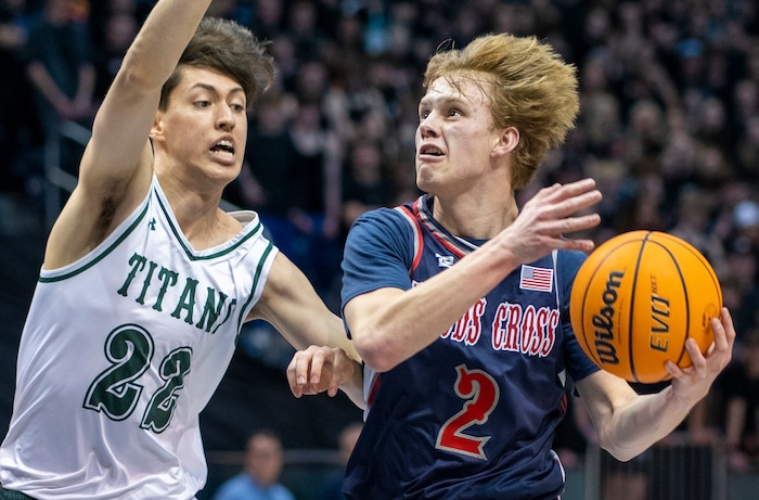 (Rick Egan | The Salt Lake Tribune) 
Woods Cross guard, Zach Delange (2) goes to the hoop, as Olympus Titan Olympus forward, Lucas McKane (22) defends, in the 5A State Championship game between Woods Cross and Olympus, at the Marriott Center in Provo, on Saturday, March 5, 2022.