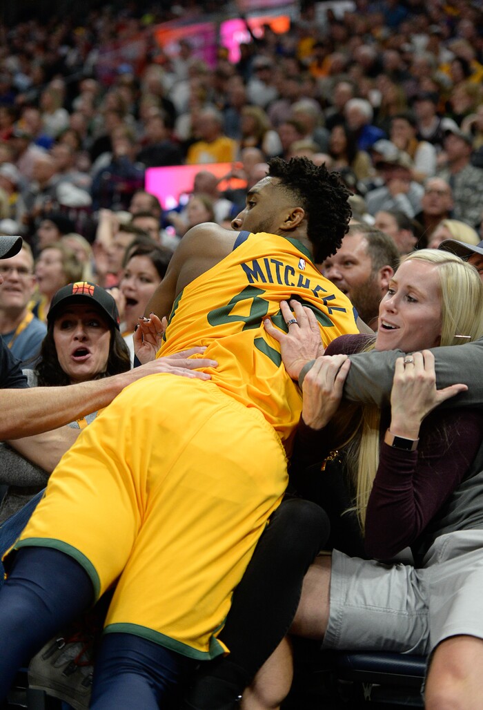 (Francisco Kjolseth  |  The Salt Lake Tribune)  Utah Jazz guard Donovan Mitchell (45) ends up in the stands chasing down a ball as the Utah Jazz host the Philadelphia 76ers in their NBA basketball game at Vivint Smart Home Arena in Salt Lake City on Wed. Nov. 6, 2019.