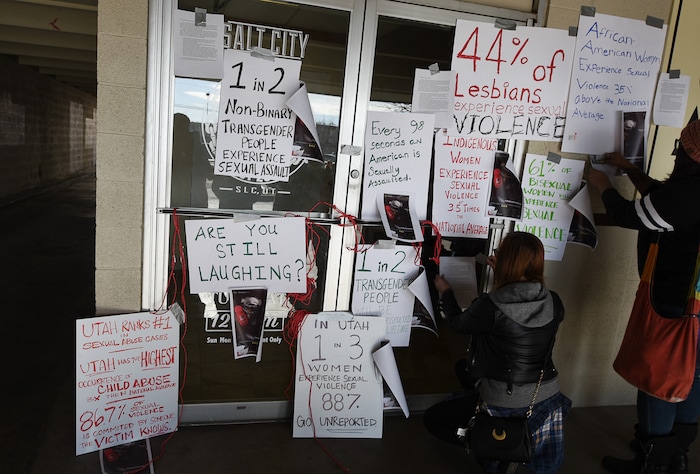 (Francisco Kjolseth | The Salt Lake Tribune) Activists in Utah cover the entry to Salt City Tattoo on Friday, Dec. 22, 2017, to protest following an Instagram post made by the shop's official Instagram account. The post in question was of a gift provided during the shop's white elephant exchange, a gift one of the artists at the parlor called a "rape kit," containing leather gloves, black duct tape, a bottle of lubricant, rope, and a knife.