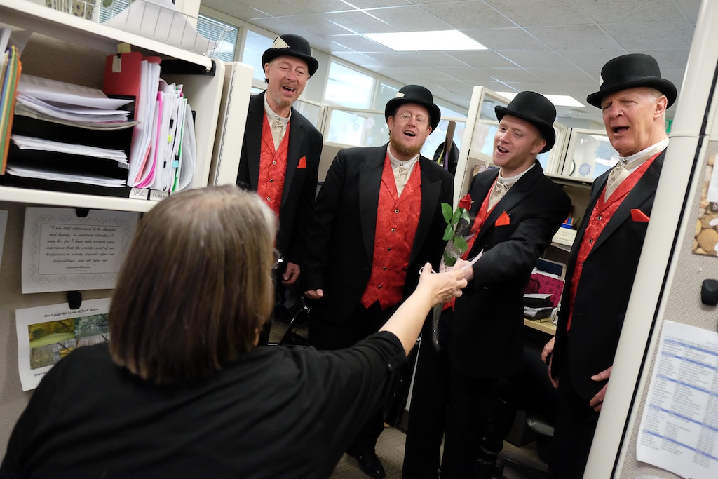 (Francisco Kjolseth | The Salt Lake Tribune) Corry Hill, left, gets a special delivery at the Utah Capitol as her husband Lynn Hill orders her a singing gram for Valentine' Day performed by the Deck of Bards on Tuesday, Feb. 14, 2017. From left, Ted Pierce, Jim Davis, Chris Wiggins and Steve Smith deliver the barbershop tunes.