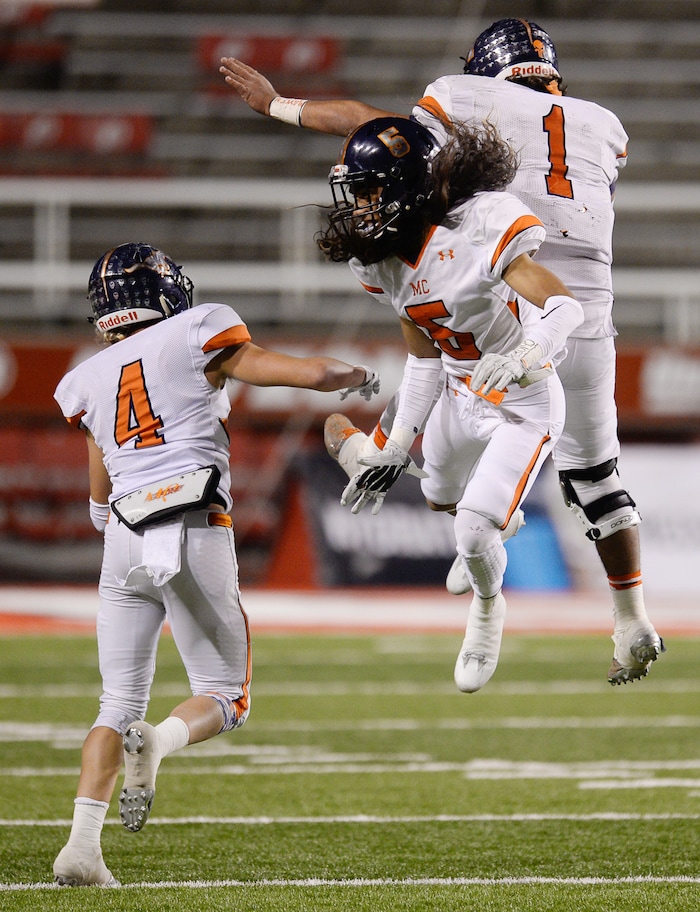 (Francisco Kjolseth  |  The Salt Lake Tribune)  Mountain Crest players Kyler Olsen, Lehi Taukiuvea and Brady Hall, from left, celebrate their 17-7 semifinal win over Stansbury in their class 4A game at Rice-Eccles Stadium, Thursday, Nov. 9, 2017.