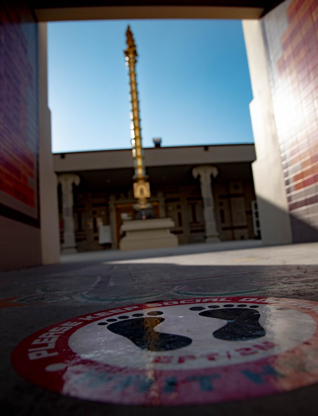 (Francisco Kjolseth  |  The Salt Lake Tribune) Stickers promoting social distancing are placed on the ground outside of the Sri Ganesha Hindu Temple in South Jordan in an effort to maintain safety during the coronavirus pandemic. Thought the temple remains closed on weekdays, a few slots are available for signup on the weekend under limited hours.