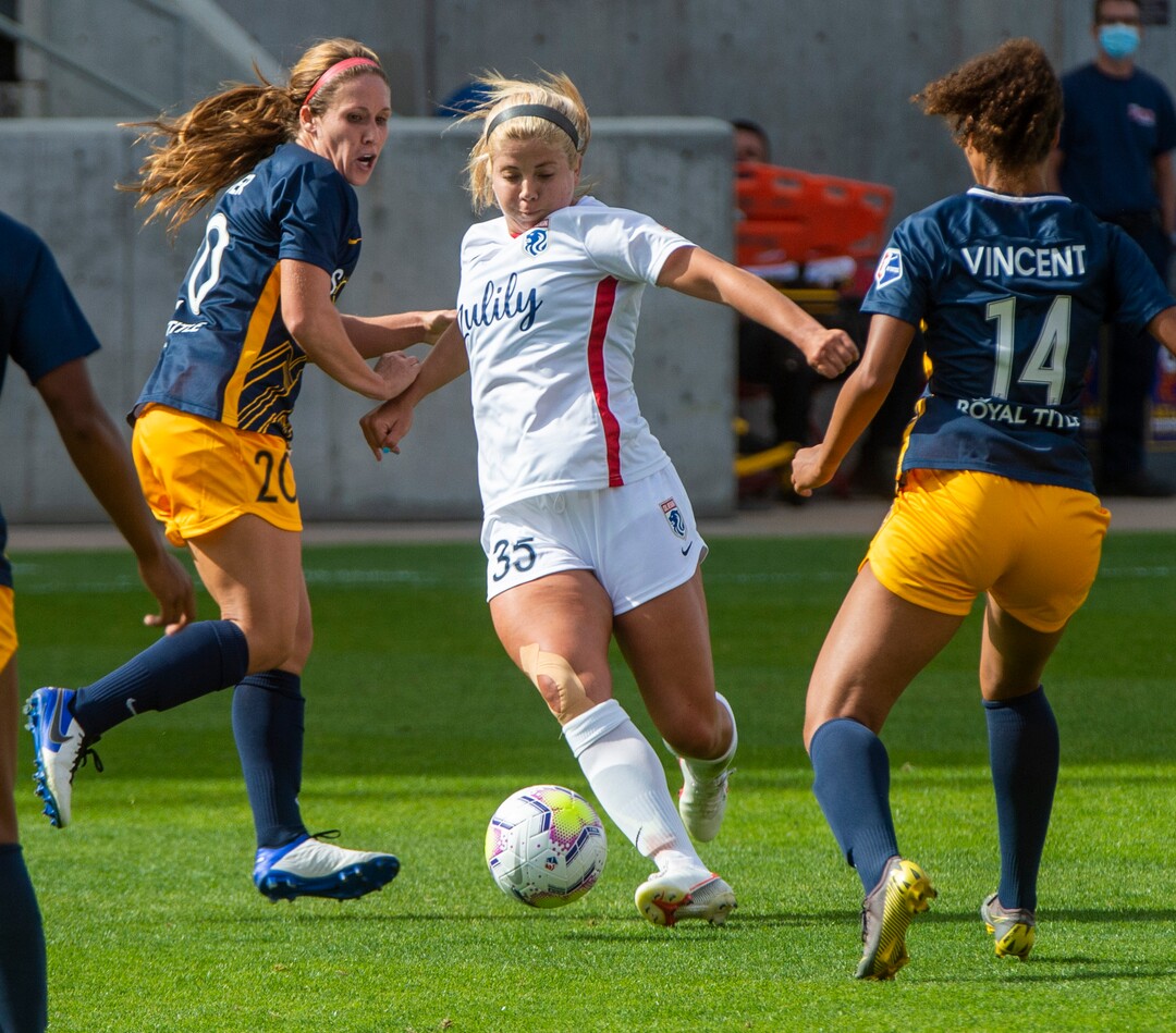 (Rick Egan  |  The Salt Lake Tribune) Ol Reign FC attacker Leah Pruitt goes for the ball as OL Reign FC midfielder Rumi Utsugi (20) and OL Reign FC Defender Gaby Vincent  (14) defends, in soccer action between Utah Royals FC and Ol Reign FC at Rio Tinto Stadium in Sandy, Saturday, Sept. 26, 2020.