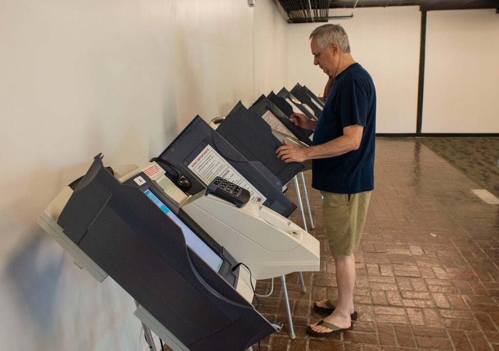(Rick Egan | Tribune file photo) Mark Sadler casts his ballot during early voting at Trolly Square on Aug. 12, 2019.