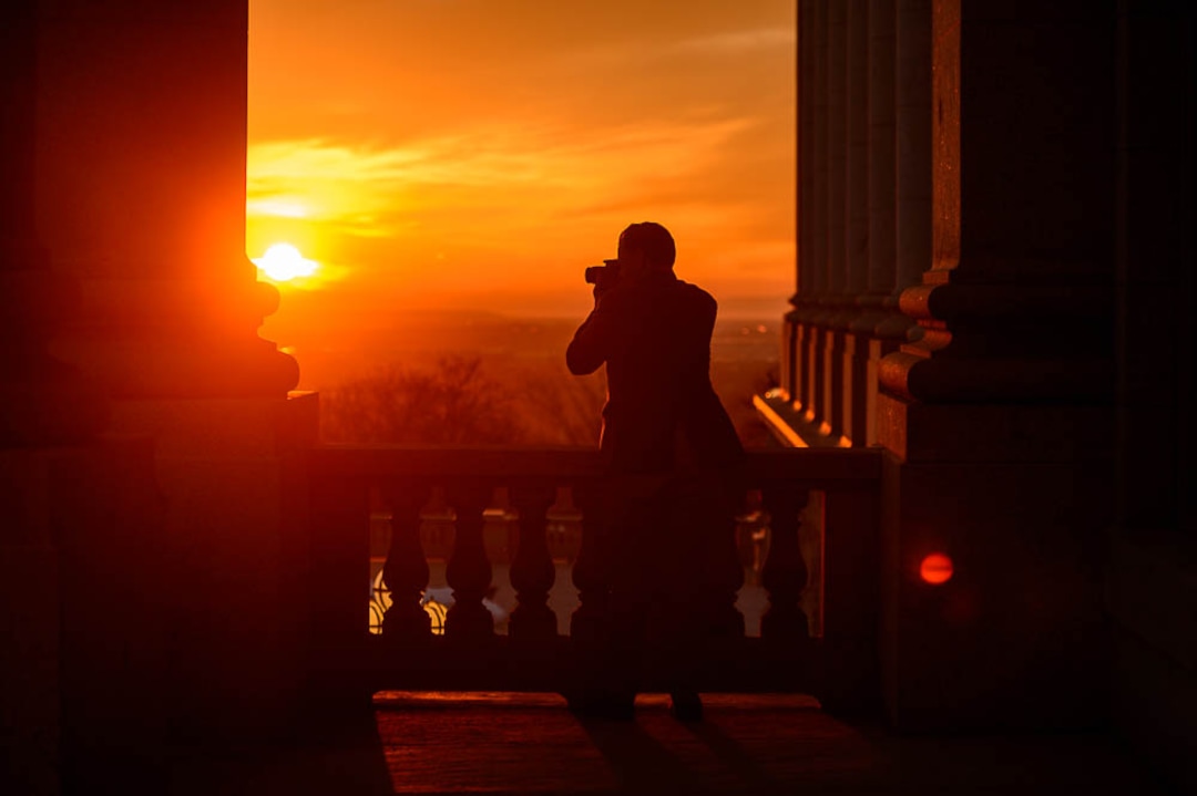 (Trent Nelson | The Salt Lake Tribune)  Jared Mendenhall photographs from the Utah capitol as the sun sets in Salt Lake City, Thursday March 8, 2018.
